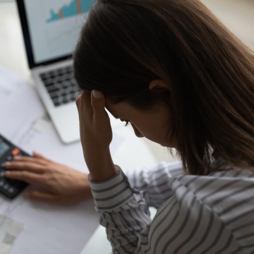 Woman in distress with calculator