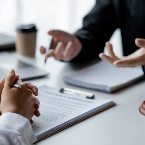 Two people in a legal protection meeting