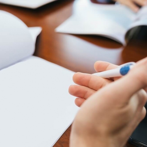 Business meeting with pen in hand