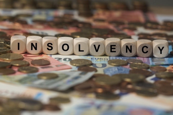 How does an accountant spot potential signs of client insolvency?